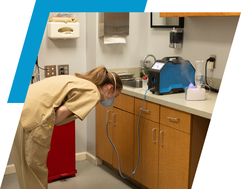 A woman bending over in the kitchen with her head down.